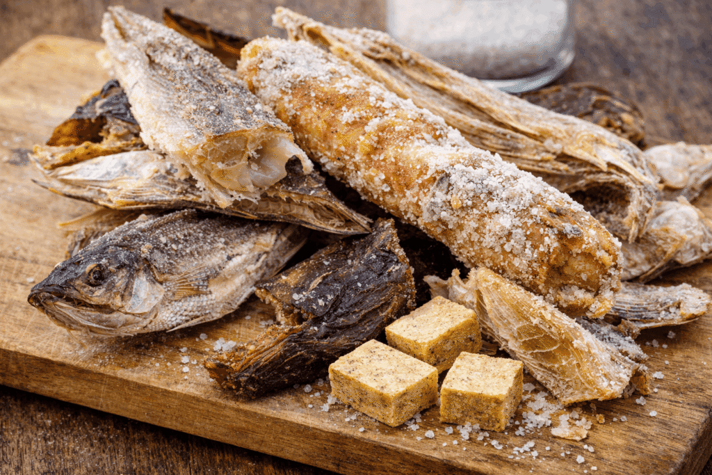 Salted dried fish and seasoning cubes on a wooden board